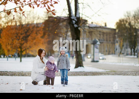 Young mother and two kids having fun on winter day Stock Photo