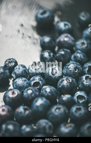 Fresh blueberry texture, wallpaper and background. Wet dark forest blueberries on dark background, selective focus. Summer food or local market produc Stock Photo