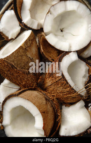 Close up view pf cracked coconuts arranged in metallic tray Stock Photo