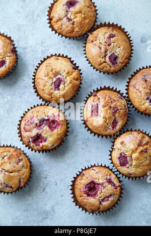 Raspberry and white chocolate muffins on light grey background Stock Photo