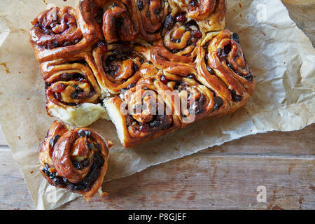 Chelsea Buns on cooling rack with glaze Stock Photo
