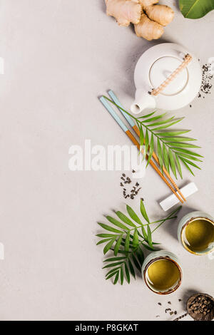 Asian food background - tea and chopsticks on a grey concrete background. Top view, flat lay Stock Photo