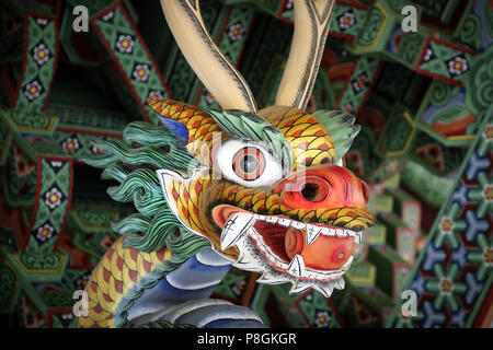 Colorful dragon face sculpture that looks scary. Stock Photo