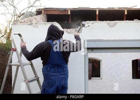 Berlin, Germany, artisan beating a wall in the rebuilding of a gazebo Stock Photo