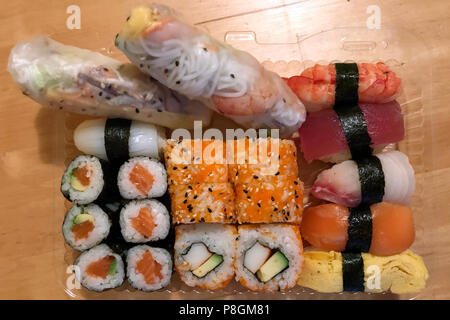 Berlin, Germany, sushi and filled rice paper rolls in a plastic cup Stock Photo