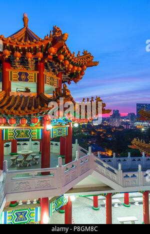 Thean Hou Buddhist Temple decorated with lanterns at dusk with the city skyline on the background, Kuala Lumpur, Malaysia Stock Photo