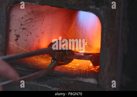 Neustadt (Dosse), horseshoe is heated in an oven Stock Photo