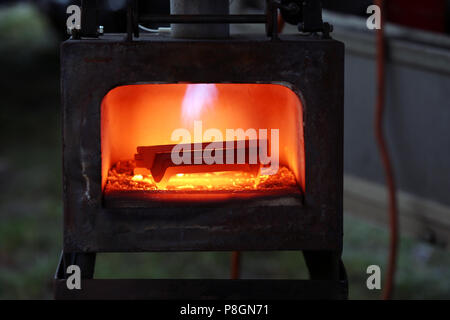 Neustadt (Dosse), horseshoes are heated in an oven Stock Photo