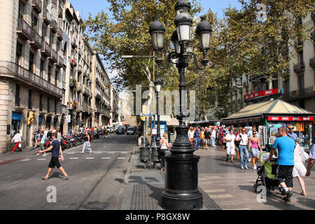 BARCELONA, SPAIN - SEPTEMBER 13: Tourists stroll famous Ramblas on September 13, 2009 in Barcelona, Spain. Rambla boulevard is one of the most recogni Stock Photo