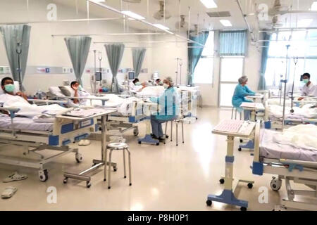 Bangkok. 11th July, 2018. Boys rescued from the Thai cave wear masks and rest at a hospital in Mae Sai, Chiang Rai province, northern Thailand, in a still image taken from a July 11, 2018 handout video. According to reports, all 12 boys of a child soccer team and their assistant coach have been rescued and evacuated to a hospital. Credit: Xinhua/Alamy Live News Stock Photo