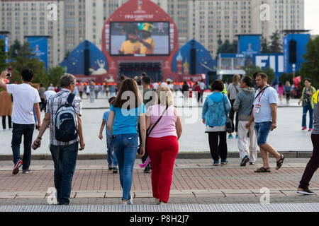 Moscow, Russia. 11th July, 2018. Fan Festival area on Sparrow Hills. Football fans gather to view England vs Croatia semi-final on large TV screens. Concert and activity before the match. In spite of local thunderstorms over Moscow, the festival atmosphere is warm. Credit: Alex's Pictures/Alamy Live News Stock Photo