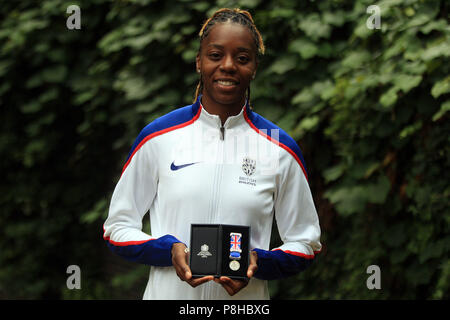 London, UK. 11th July, 2018. Lorraine Ugen of Great Britain poses with her medal.  all the athletics world cup team captains, all Women, today are presented with unique Platinum captain's medals marking 100 years since first British women secured the right to vote.  Athletics World Cup media day at the Terrace Gallery, Museum of London in London on Thursday 12th July 2018. Credit: Andrew Orchard sports photography/Alamy Live News Stock Photo