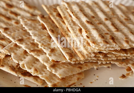 Close up square pieces of matzo flatbread crackers, traditional Jewish crispbread Stock Photo