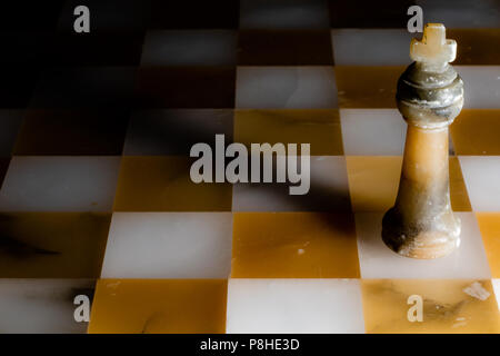 The black king on a stone chessboard Stock Photo