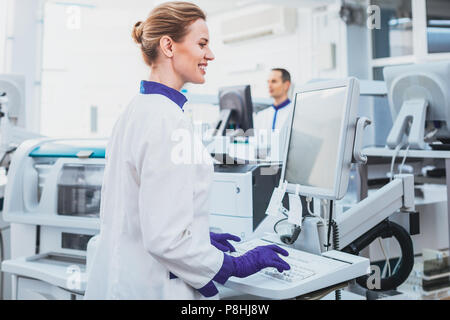 Happy medical worker doing experiment Stock Photo