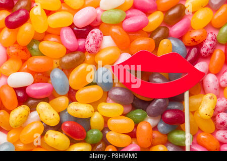 Sweet jelly beans and red paper lips. Stock Photo