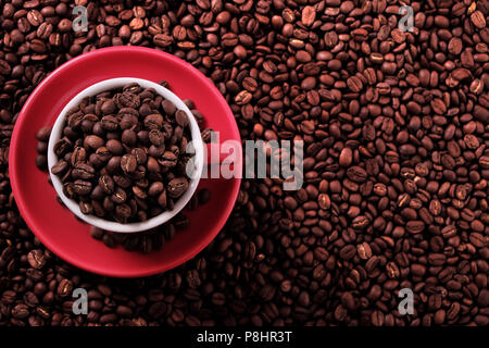 Red coffee cup filled with roasted beans Stock Photo