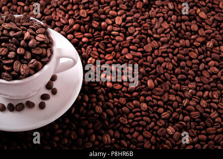 White coffee cup filled with roasted beans Stock Photo