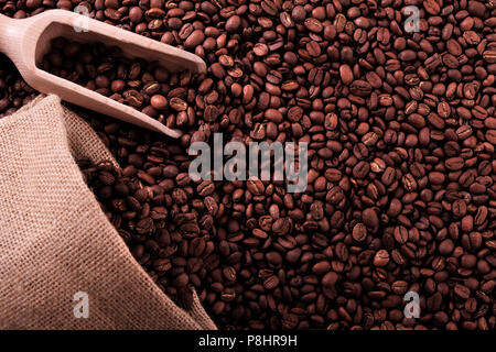 Coffee beans background with sack and scoop Stock Photo