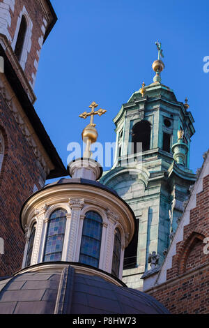 The dome of the chapel of Kings Vase on the background of the clock tower - Wawel Cathedral. Krakow. Poland Stock Photo
