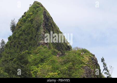 View of a near Ko’olau Mountains mountain peak from Nu'Uanu Pali Lookout. You might see people on the Koolaus Summit Trail also know as the Pali Puka  Stock Photo