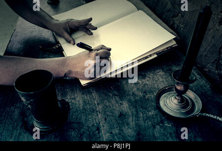 Old medieval desk with pen and book, detail of place to read and write Stock Photo