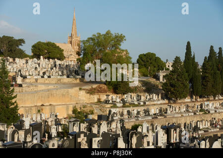 a view over gravesones to the chapel of the Addolorata Cemetery, Malta Stock Photo
