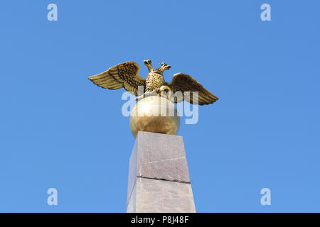 Golden two-headed eagle of Russia sculpture atop the Stone of the Empress obelisk in Market Square, Helsinki Stock Photo