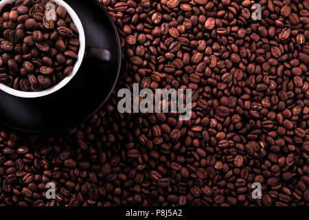 Black coffee cup with roasted beans background Stock Photo