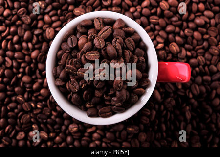 Red coffee mug filled with beans top view Stock Photo