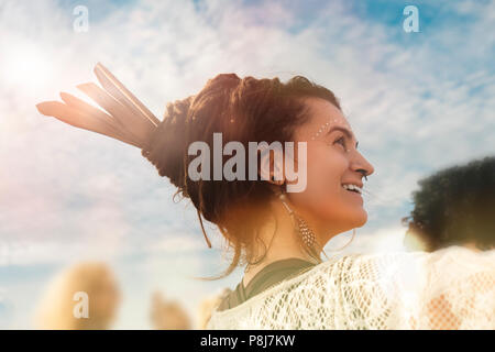 A smiling hippie young woman in crowed wearing dread-locks, yearly Arambol Freak Show, 8th February 2018, India Stock Photo