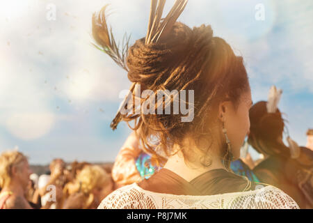 A smiling hippie young woman in crowed wearing dread-locks, yearly Arambol Freak Show, 8th February 2018, India Stock Photo