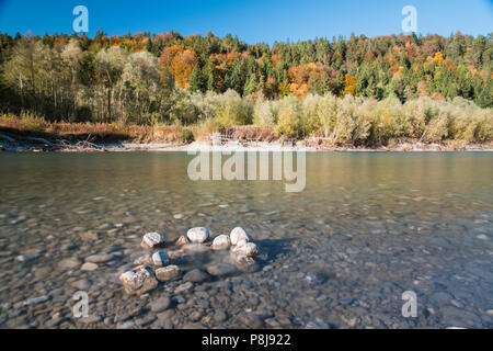 The river Lech with autumnal forest near the Ziegelwiesen, Füssen, Bavaria, Germany