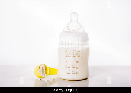 Baby bottle and milk on white background. Stock Photo