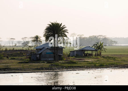Khulna, Bangladesh, March 1 2017: Huts in the morning fog at a riverside in Bangladesh Stock Photo