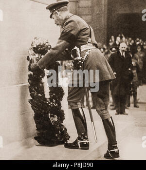 The Cenotaph War memorial was unveiled by King George V on 11 November 1920, the second anniversary of the Armistice with Germany which ended the First World War. The unveiling ceremony was part of a larger procession bringing the Unknown Warrior to be laid to rest in his tomb nearby in Westminster Abbey. The funeral procession route passed the Cenotaph, designed by Edwin Lutyens, where the waiting King laid a wreath on the Unknown Warrior's gun-carriage before proceeding to unveil the memorial which was draped in large Union Stock Photo