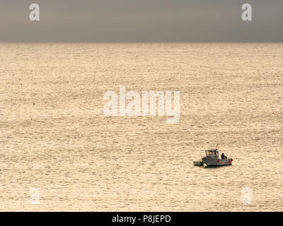 ST IVES, ENGLAND - JUNE 19: A fisherman setting gear off the coast of St Ives. In St Ives, Cornwall, England. On 19th June 2018. Stock Photo