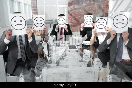 Image of businessman holding drawing of upset face. Stock Photo