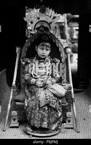 The LIVING GODDESS in her full regalia sits on her thrown during the Rato Machendranath Festival - PATTAN, NEPAL Stock Photo