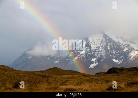 Rainbow arc in front of part of the Torres del Paine range, Patagonia. Stock Photo