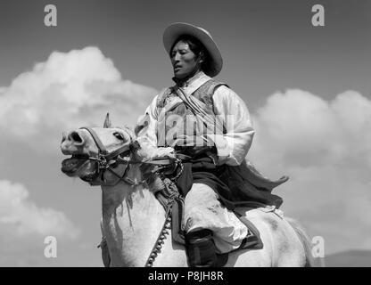 Khampas, the warrior horseman of old Tibet,  compete at the Litang Horse Festival - Kham, Sichuan Province, China, (Tibet) Stock Photo