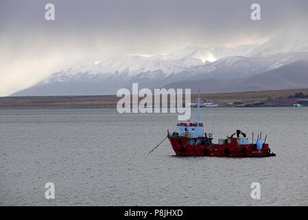 Fishing boat anchored in the waters of the Last Hope Sound, near the fishing port of Puerto Natales, in southern Chile. Stock Photo