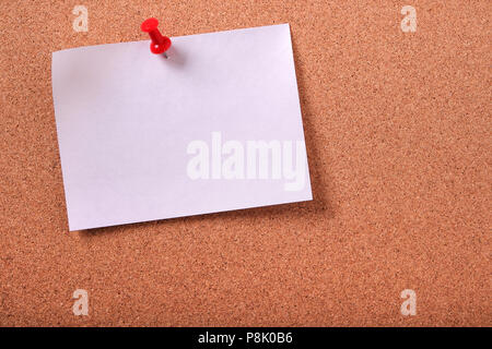 One white sticky post note pinned cork bulletin board Stock Photo