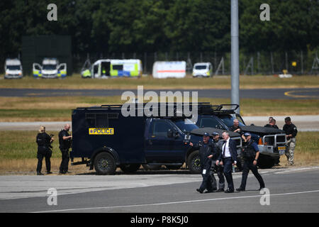 Security and police wait for the arrival of US President Trump and Melania Trump at Stansted Airport, London, in Air Force One, for their first official visit to the UK. Stock Photo