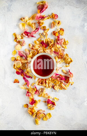 Cup of tea and dried rose petal, flat lay shot Stock Photo