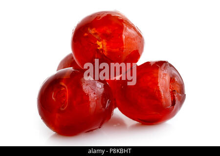 Closeup of four red glace cherries isolated on white. Stock Photo