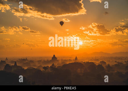Sunrise over the legendary temple city of Bagan with a hot ai balloon passing by