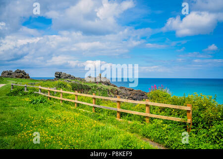 Wooden security protective fence barrier on the coastal path along the Cornish coast in St. Ives, Cornwall, England, UK Stock Photo
