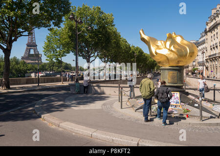 Paris, France - 23 June 2018: Tourists gather in front of the flame of freedom, an unofficial memorial for Diana, princess of Wales. Stock Photo