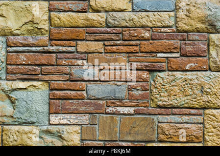 background - beige and red stone facade decoration close-up Stock Photo